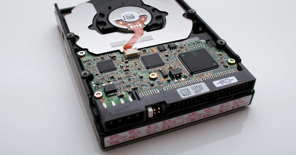 Open internal hard disk drive showing silver platters and the read/write actuator arm